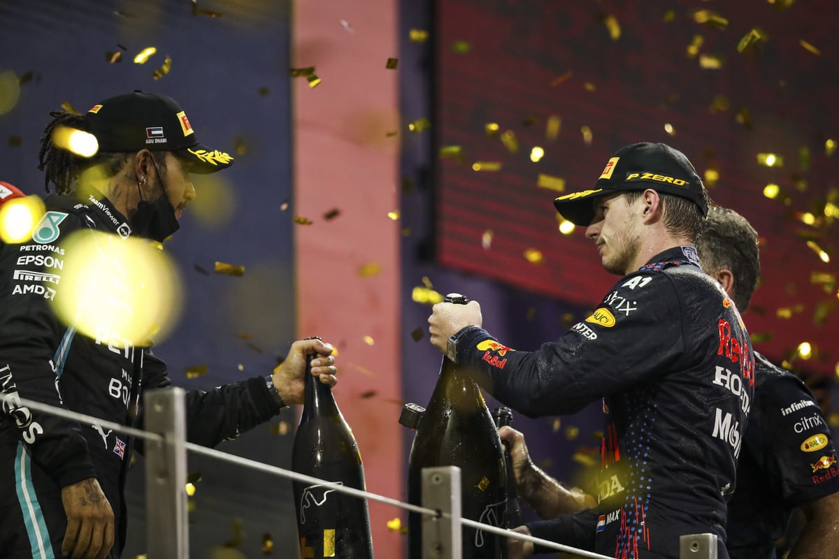 Max Verstappen and Lewis Hamilton celebrating with Champagne 