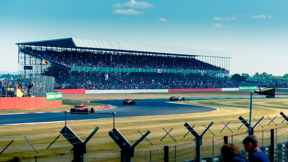 F1 cars racing round the track at Silverstone.