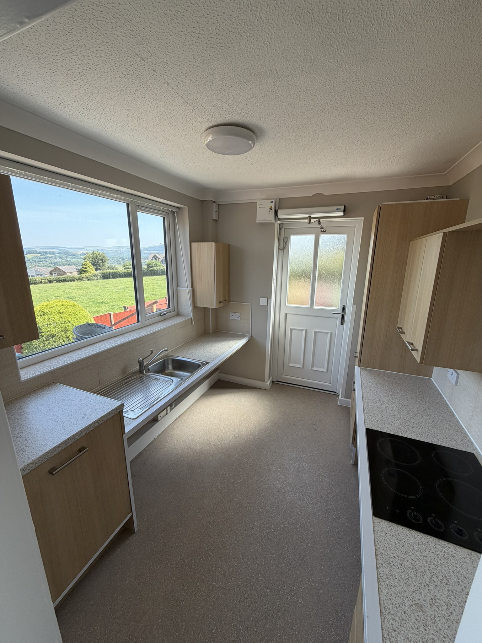 Exterior Ramped Entrance into kitchen with Door Assist To rent large one bedroom wheelchair accessible property Bolton Lancashire AccessiblePRS