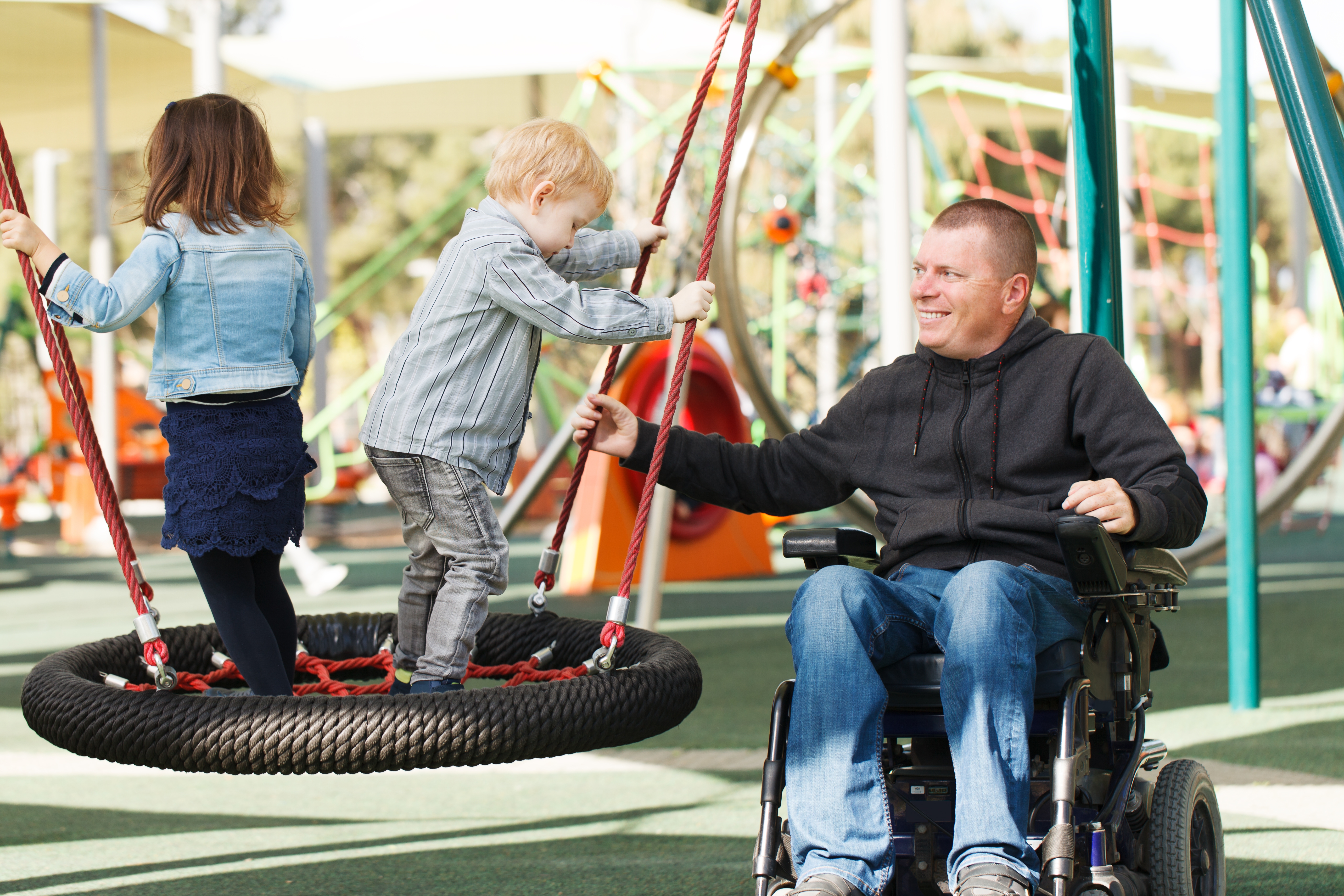 Wheelchair father playing with his kids