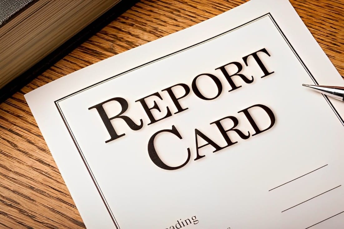 Report card lying on a wooden surface