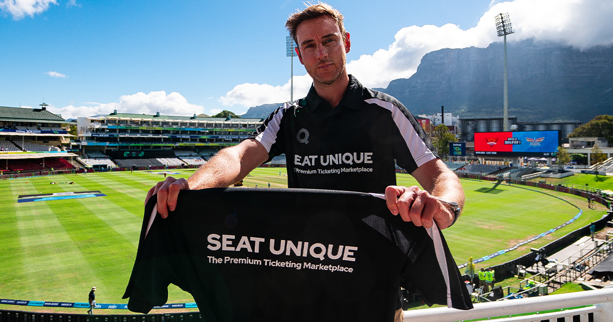 Stuart Broad holding a Seat Unique cricket shirt