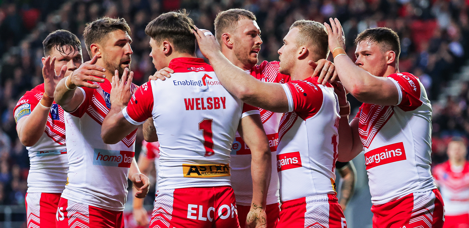 St.Helens Rugby team huddle together on pitch