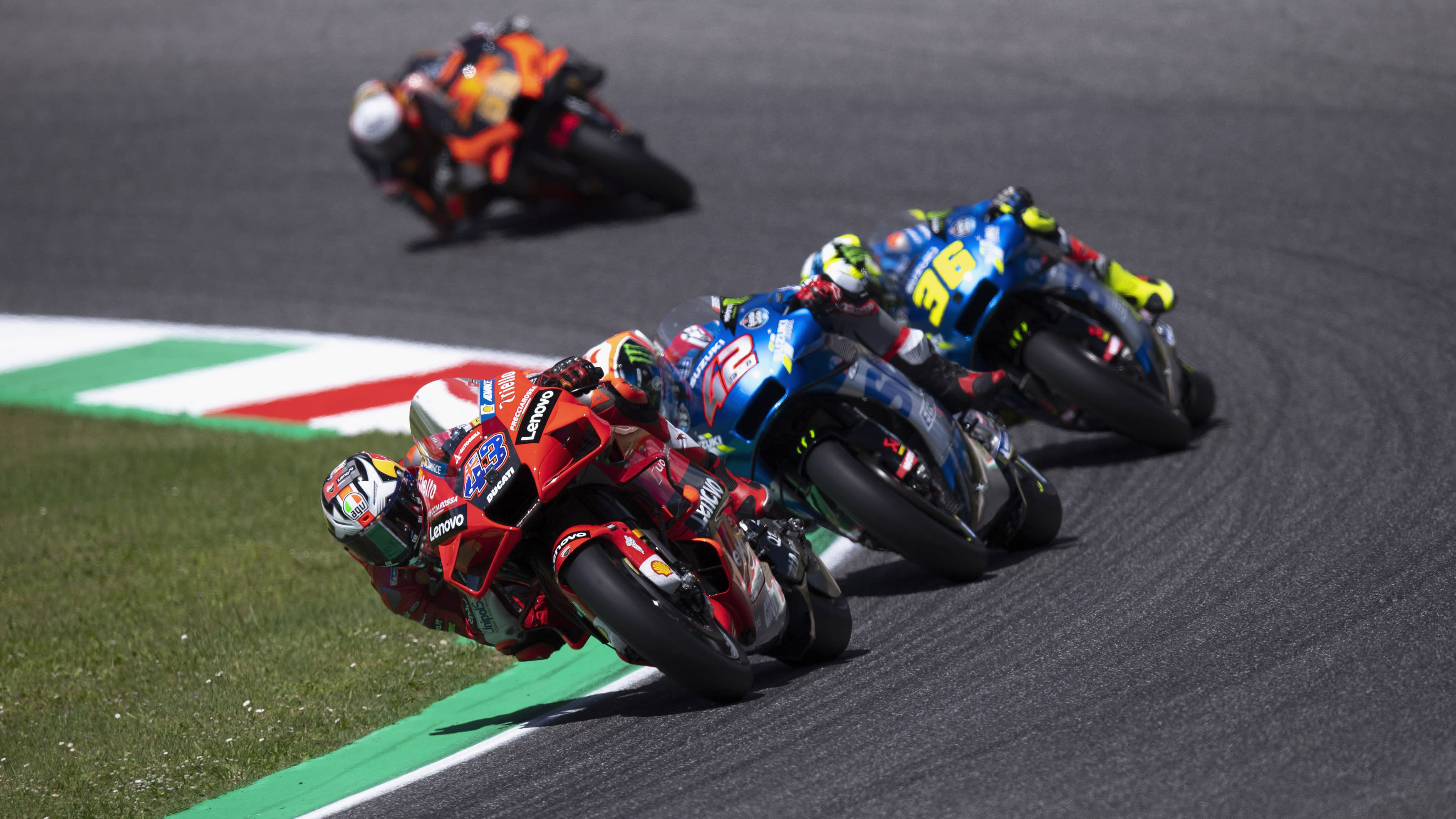 MotoGP racers going round a track bend.