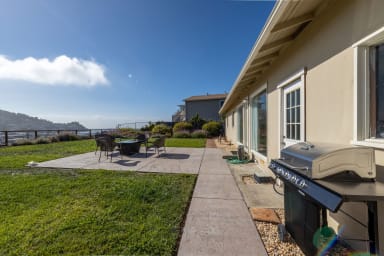 Terrace with grill, dining set, and stunning ocean view