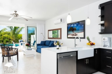 Little Plum's living room & kitchen with direct access to the private pool.