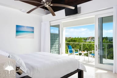 Little Plum's master bedroom and balcony with views of Turtle Cove Marina.