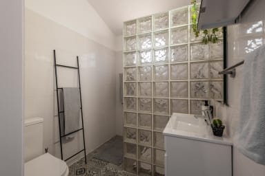 Second bathroom with big walk in shower, toilet and sink