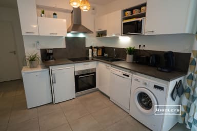 Cuisine toute équipée avec four, lave vaisselle et lave linge.