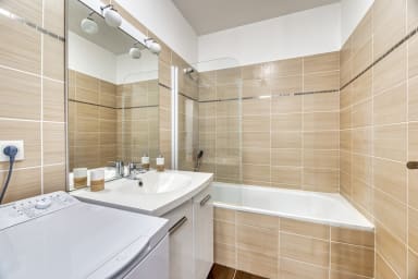 Salle de Bain avec baignoire et machine à laver