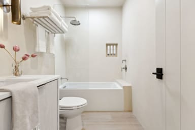 En-suite bathroom with tub, rain shower, custom vanity & high-end toiletries