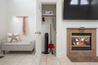 Elegant fireplace beside the cleaning and iron closet