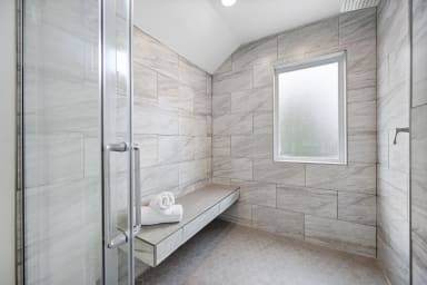 Comfortable bathroom featuring a shower and toilet for convenience