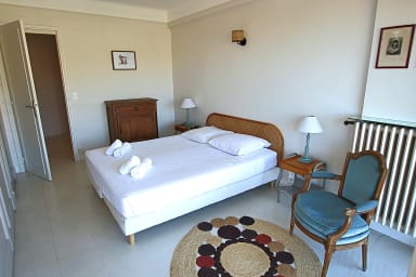 Air-conditioned bedroom with a double bed, opening onto a terrace and a view.