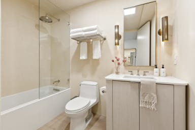 En-suite bathroom with rain shower, bathtub, and high-end toiletries