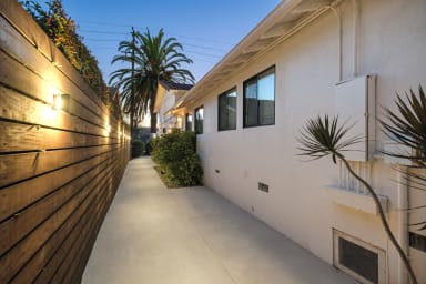 Gather in our cozy backyard retreat, illuminated by gentle, warm light.