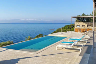 Relax by the infinity pool, basking in sunshine and sweeping Ionian views.