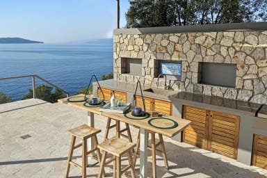 Cook, dine, and soak in mesmerizing water views from the outdoor kitchen.