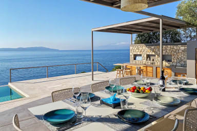 Chic dining by the pool—enjoy meals with panoramic sea and mountain views.