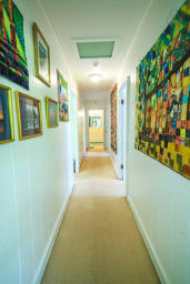 hallway with art work from the owner
