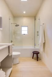 Bathroom with combination tub and rain shower + high-end toiletries