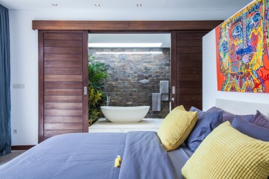 King size bed of the bedroom 1, with the view on the private en-suite in the...