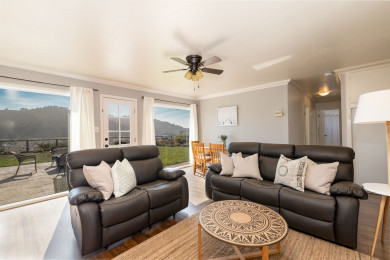 Refined sitting area with sofas, table, and window views