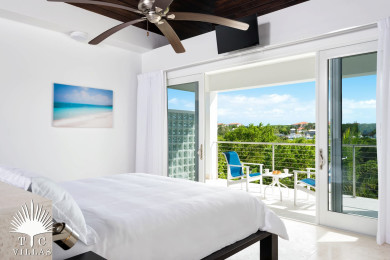 Little Plum's master bedroom and balcony with views of Turtle Cove Marina.