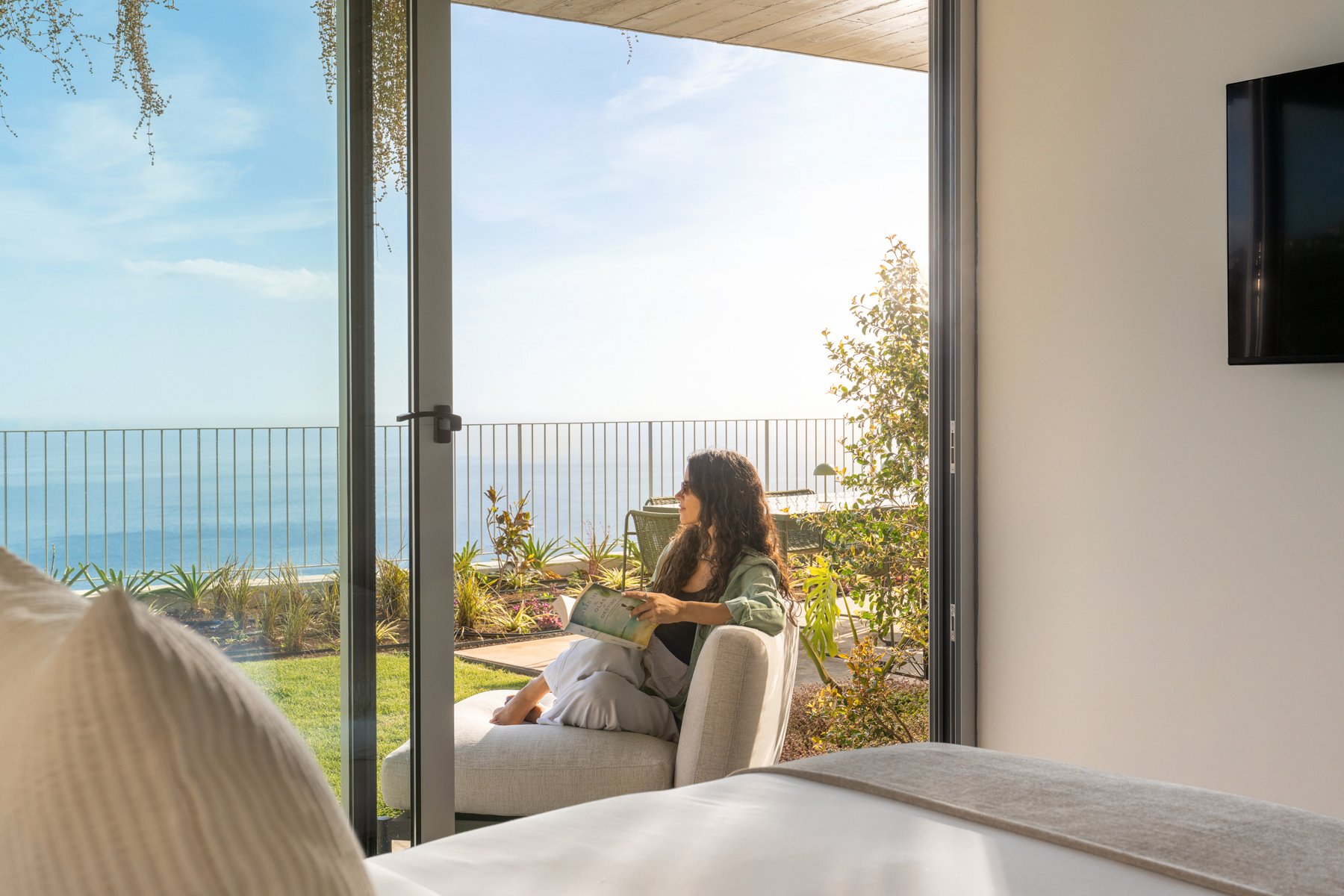 Reading beside the ocean at Casa Mareva, Madeira