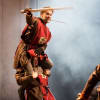 Ciaran Kellgren as Robin Hood on top of Oliver Llewellyn-Jenkins as a soldier