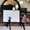 Sarah Golding, Alys North and Peter Pearson of Adam Russell Dance rehearse in the Great Hall of The Discovery Museum