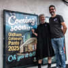 Actor and Coliseum campaigner Julie Hesmondhalgh next to the poster for the 2025 panto at the announcement event in July 2024