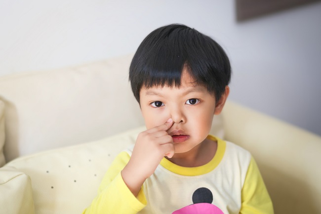 An,Asian,Boy,Blowing,His,Nose.