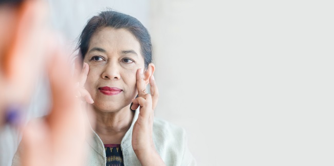 Senior,Adult,Women,Show,Her,Crow's,Feet,On,The,Mirror.concept