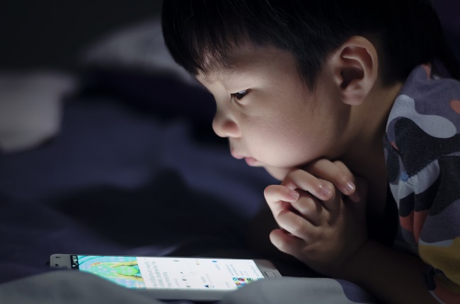 Boy,Asia,Play,Telephone,On,Bed,At,Night,.