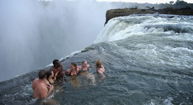 Swimming in the Devil's Pool of Zambezi at Victoria Falls in Africa.
