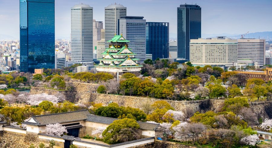Enchanting Travels Japan Tours Osaka Japan city skyline at the castle and business park in the spring.