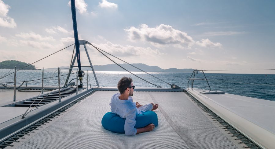 happy holiday Luxury Travel by Catamaran in the Ocean by the Seychelles island, Young man at sailing boat