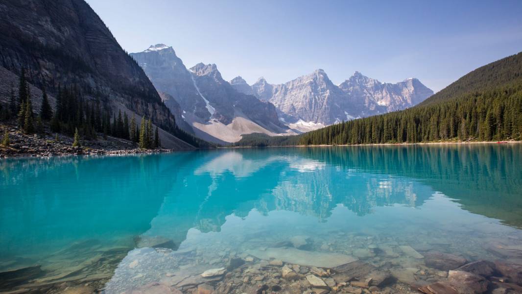 a body of water with a mountain in the background