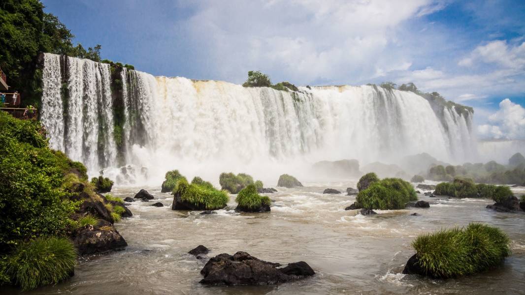 a large waterfall over a body of water