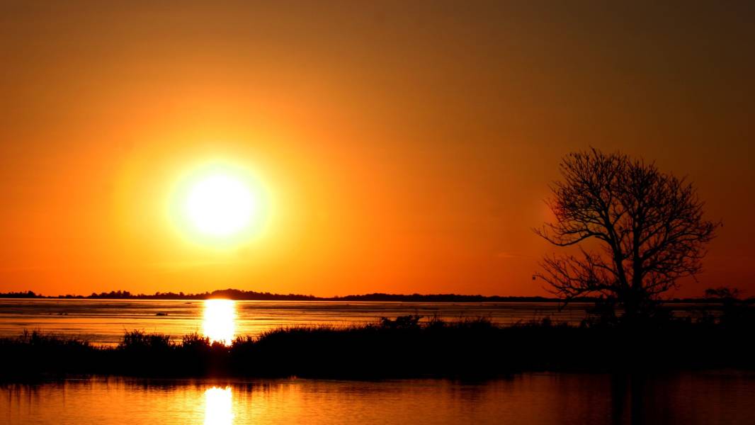 a sunset over a body of water