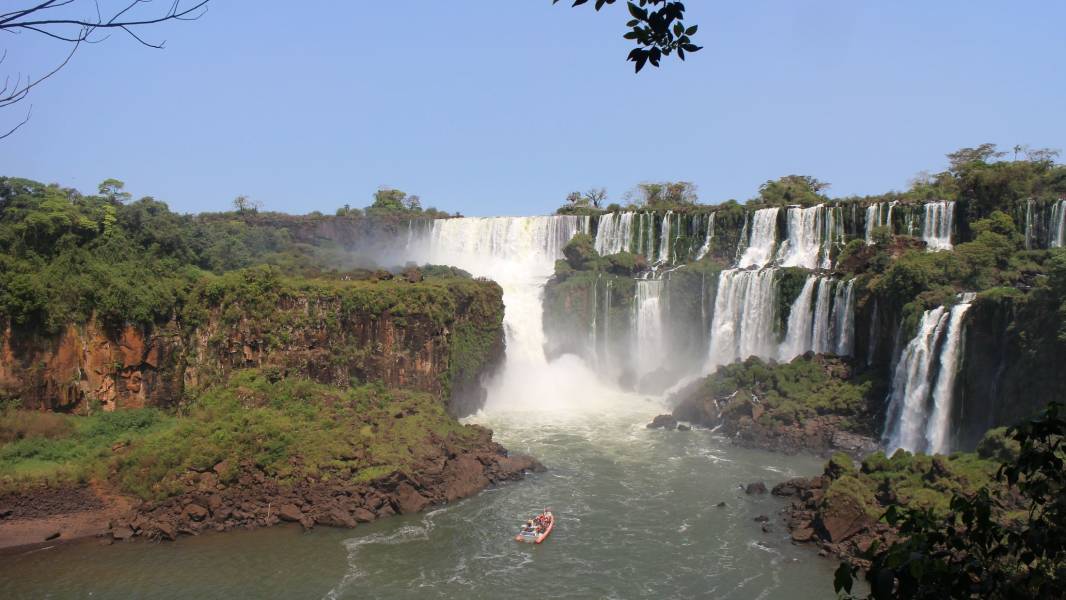 a large waterfall over a body of water