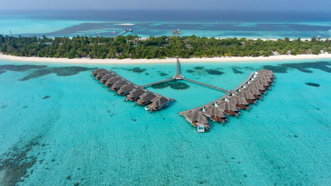 a group of lawn chairs sitting on top of a beach