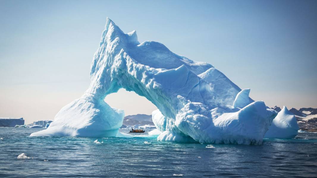 a large body of water with a mountain in the background