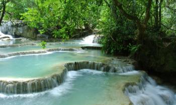 a large waterfall and a pool of water