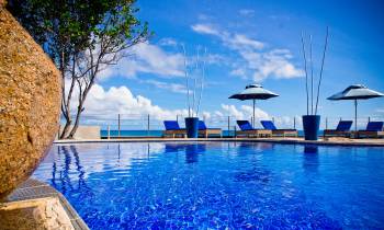 a blue and white boat sitting next to a pool of water