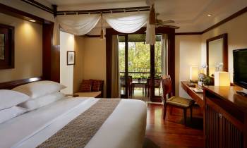 a bedroom with a large bed in a hotel room