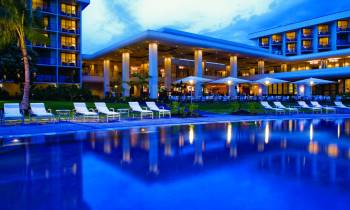 a blue pool of water in front of a building