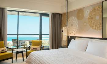 a bedroom with a large bed in a hotel room