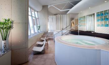 a large white tub next to a window